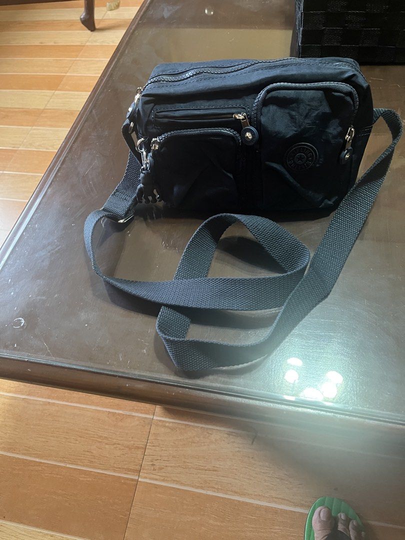 Kipling Navy blue Crossbody Bag with Multiple Zips (Category: Cross-body Bags) located in Taguig. Submitted by leticia_123 (Listing ID 1468571750, Image 2). Description: - Authentic black Kipling crossbody bag in durable, everyday nylon fabric - Sturdy and adjustable strap for comfortable all-day wear - Secure top main zip closure to keep your belongings safe - Multiple front zip compartments for hassle-free organization - Iconic round Kipling lo