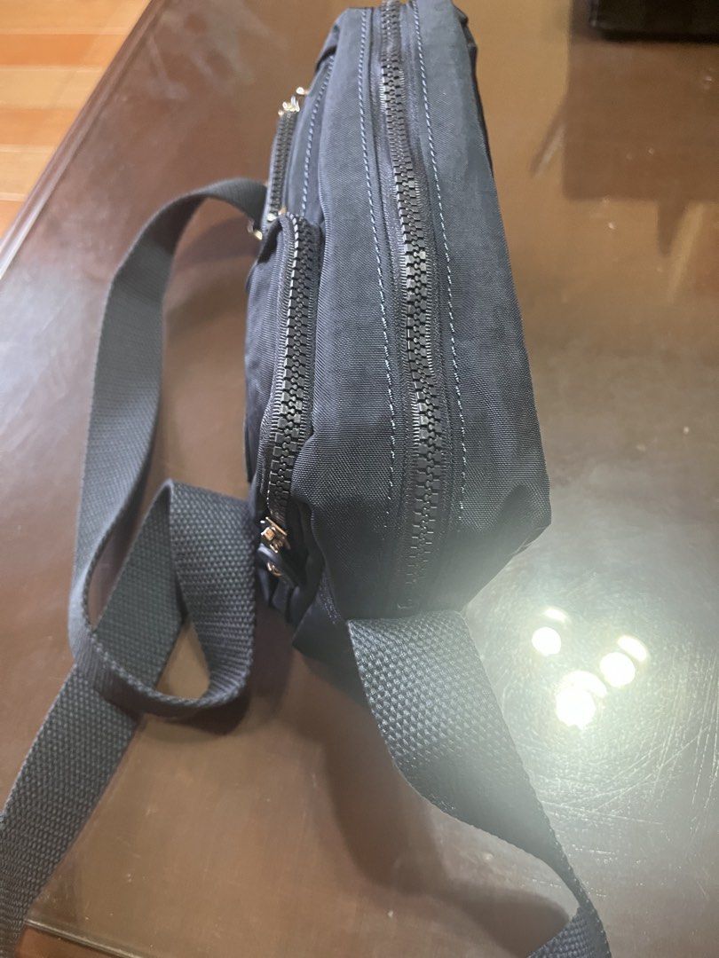 Kipling Navy blue Crossbody Bag with Multiple Zips (Category: Cross-body Bags) located in Taguig. Submitted by leticia_123 (Listing ID 1468571750, Image 3). Description: - Authentic black Kipling crossbody bag in durable, everyday nylon fabric - Sturdy and adjustable strap for comfortable all-day wear - Secure top main zip closure to keep your belongings safe - Multiple front zip compartments for hassle-free organization - Iconic round Kipling lo