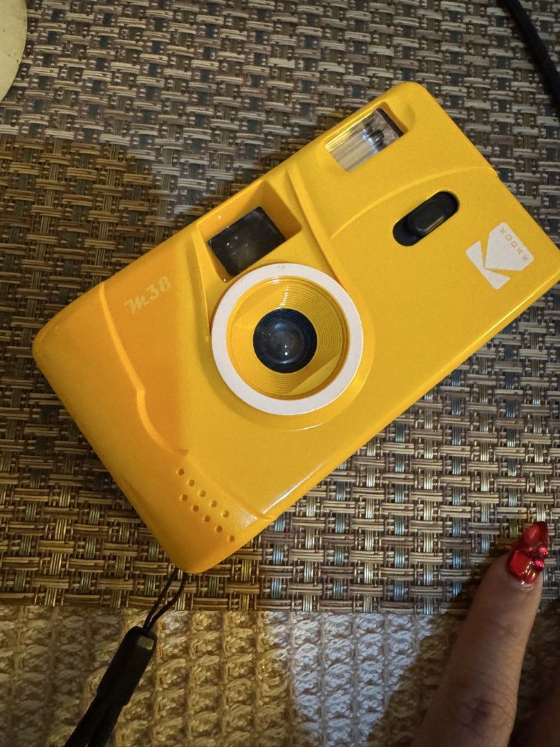 Kodak M38 Yellow Reusable Film Camera (Category: Cameras) located in Mandaluyong City. Submitted by nicxannc (Listing ID 1468599201, Image 1). Description: - Brand: Kodak M38 Film Camera - Color: Bright Yellow - Format: Uses standard 35mm film rolls - Lens: Fixed focus for easy point-and-shoot - Flash: Built-in flash (powered by 1x AAA battery) - Operation: Manual wind mechanism - Inclusions: Attached black wrist strap - Condition: Ready to shoot