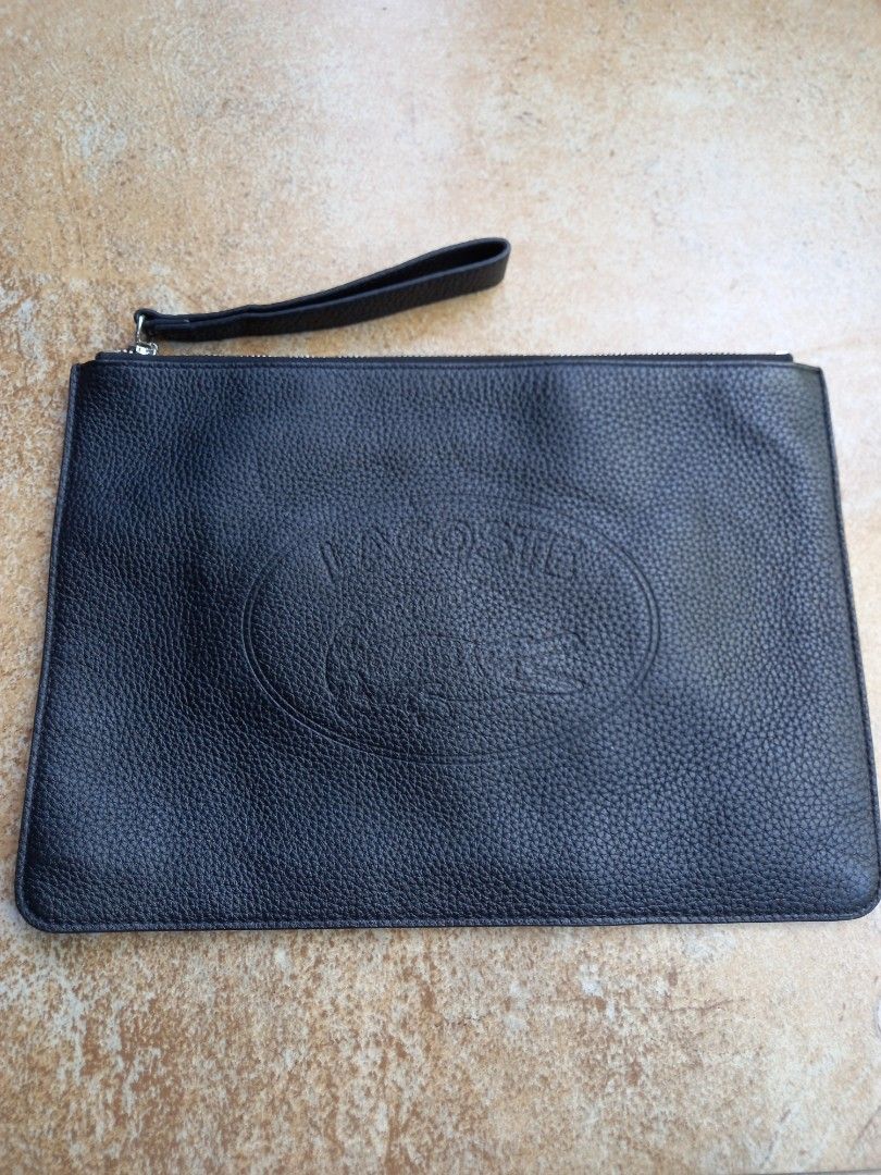 Lacoste Black Leather Pouch Clutch Bag (Category: Luxury Bags & Wallets) located in Davao. Submitted by kirk214red-50020 (Listing ID 1468531305, Image 1). Description: - Brand: Lacoste - Material: Premium black pebbled leather - Logo: Oval debossed crocodile logo on the front - Closure: Secure zip-top closure - Strap: Matching wrist strap for easy carrying - Interior: Dark fabric lining with built-in card slots - Condition: Clean stitching and st