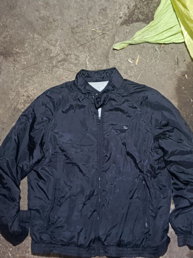 Lacoste Black Windbreaker Jacket Size 50/4 (Category: Coats, Jackets and Outerwear) located in City of Isabela. Submitted by warmbird.d06e6f (Listing ID 1468510350, Image 1). Description: - 100% Authentic Lacoste jacket in classic black - Size: 50/4 (Refer to tag) - Material: Durable nylon outer shell with soft grey polyester lining - Design: Full zip front, stand collar with snap button closure, and ribbed cuffs and hem - Pockets: Dual secure zi