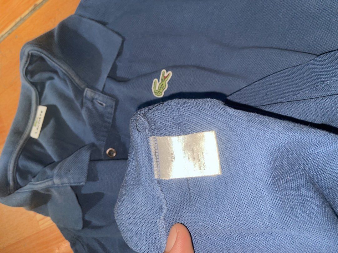 Lacoste Blue Polo Shirt (Category: Tshirts & Polo Shirts ) located in Manila. Submitted by joshua_guimeroy. (Listing ID 1468524340, Image 3). Description: - Brand: Lacoste - Color: Classic Blue - Material: 100% Cotton Piqué - Fit: Standard fit - Details: Classic collar, single-button placket, short sleeves, straight hem - Logo: Iconic embroidered green crocodile on chest - Condition: Excellent / Pre-loved - Style: Casual daily wear.
