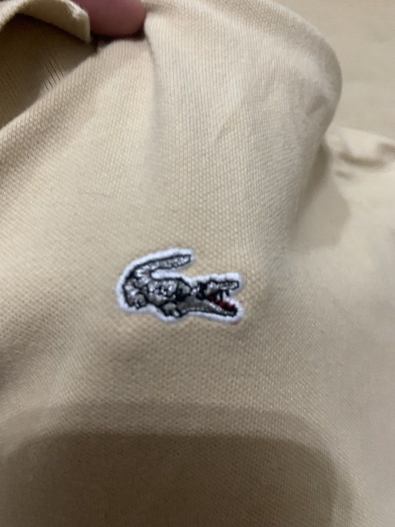 Lacoste Limitée Silver Polo Shirt Cream (Category: Tshirts & Polo Shirts ) located in Manila. Submitted by thrifty111 (Listing ID 1468620734, Image 3). Description: - Brand: Lacoste (Limitée Silver Collection) - Size: 50 - Color: Cream - Material: Classic pique cotton knit - Details: Embroidered chest logo, large lettering on back collar, branded buttons - Fit: Short sleeves, easy to style with jeans or shorts -size 20.5x25.