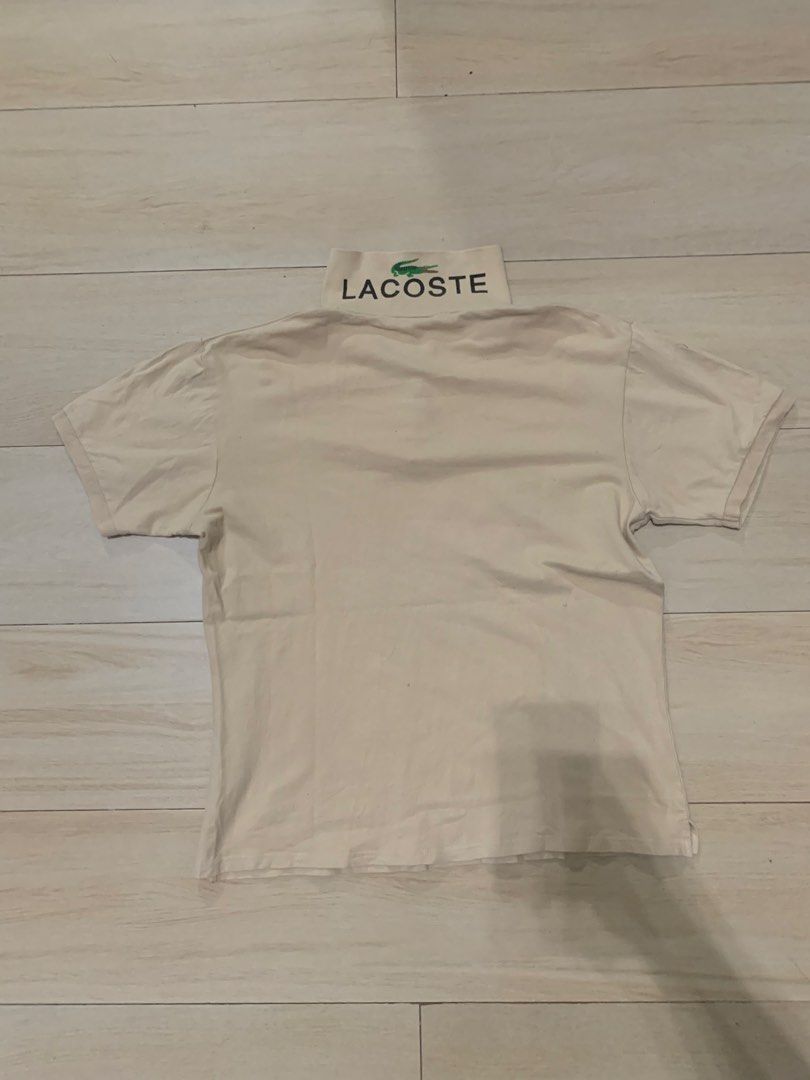 Lacoste Limitée Silver Polo Shirt Cream (Category: Tshirts & Polo Shirts ) located in Manila. Submitted by thrifty111 (Listing ID 1468620734, Image 2). Description: - Brand: Lacoste (Limitée Silver Collection) - Size: 50 - Color: Cream - Material: Classic pique cotton knit - Details: Embroidered chest logo, large lettering on back collar, branded buttons - Fit: Short sleeves, easy to style with jeans or shorts -size 20.5x25.