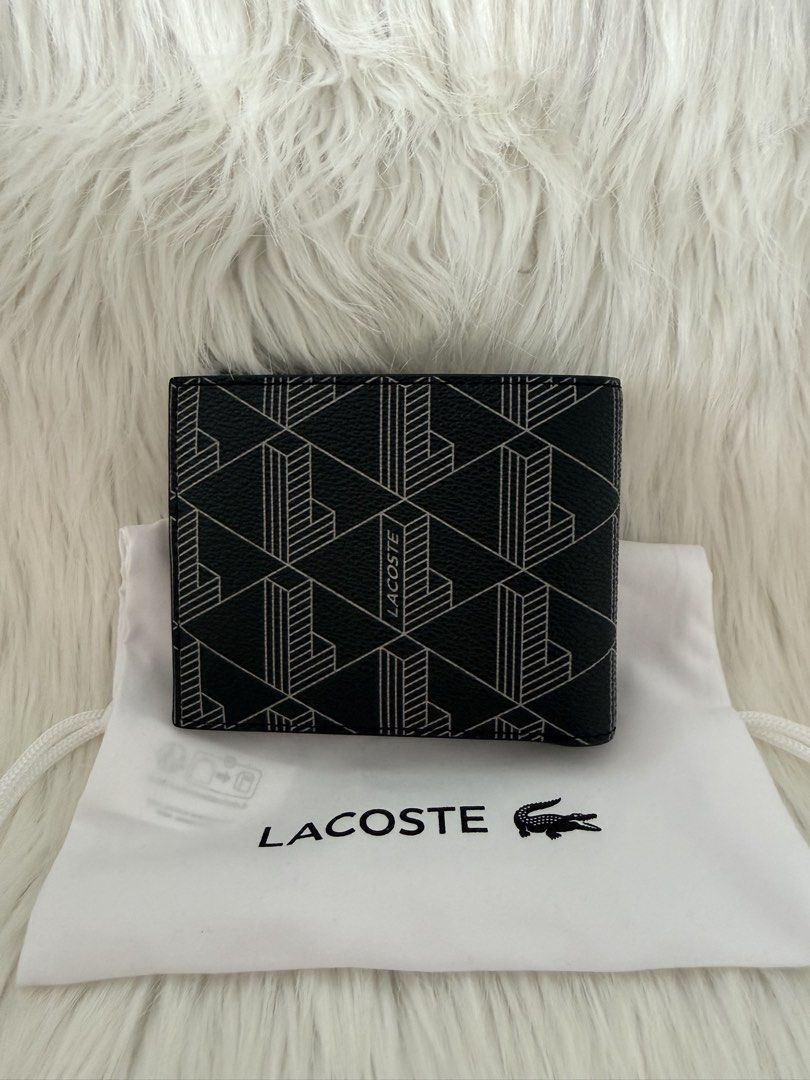 Lacoste Men’s Geometric Pattern Black bifold wallet with dust bag (Category: Wallets & Card holders) located in Cainta. Submitted by mskath__ (Listing ID 1468600951, Image 1). Description: - Brand: Lacoste - Style: Bifold wallet - Color: Classic black/Gray - Exterior: Stylish geometric line pattern with debossed branding - Interior: Multiple card slots and spacious cash compartments - Inclusion: Original dust bag - Condition: Brand new / Excellen