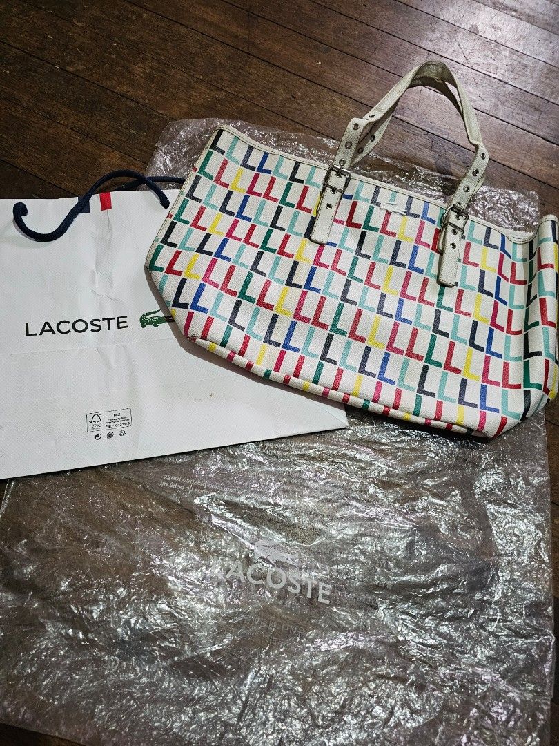 Lacoste multicolor leather bag (Category: Tote Bags) located in Manila. Submitted by onlinesmartshopping12 (Listing ID 1468503095, Image 2). Description: original - Slightly used Lacoste tote bag - Eye-catching geometric pattern - Crisp white handles and buckle - Includes original Lacoste paper bag - Comes with a protective plastic cover - with all packaging -from Hongkong Lacoste Outlet Store - some peeling of the piping in the handle.