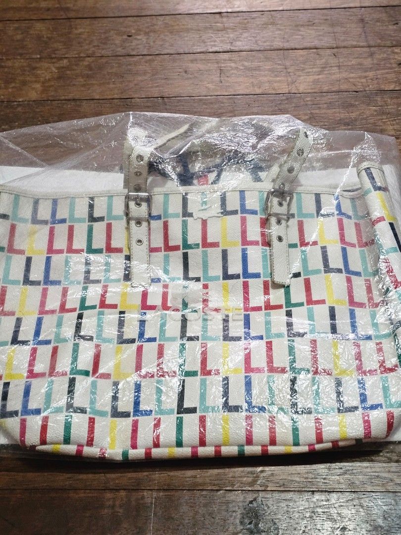 Lacoste multicolor leather bag (Category: Tote Bags) located in Manila. Submitted by onlinesmartshopping12 (Listing ID 1468503095, Image 3). Description: original - Slightly used Lacoste tote bag - Eye-catching geometric pattern - Crisp white handles and buckle - Includes original Lacoste paper bag - Comes with a protective plastic cover - with all packaging -from Hongkong Lacoste Outlet Store - some peeling of the piping in the handle.