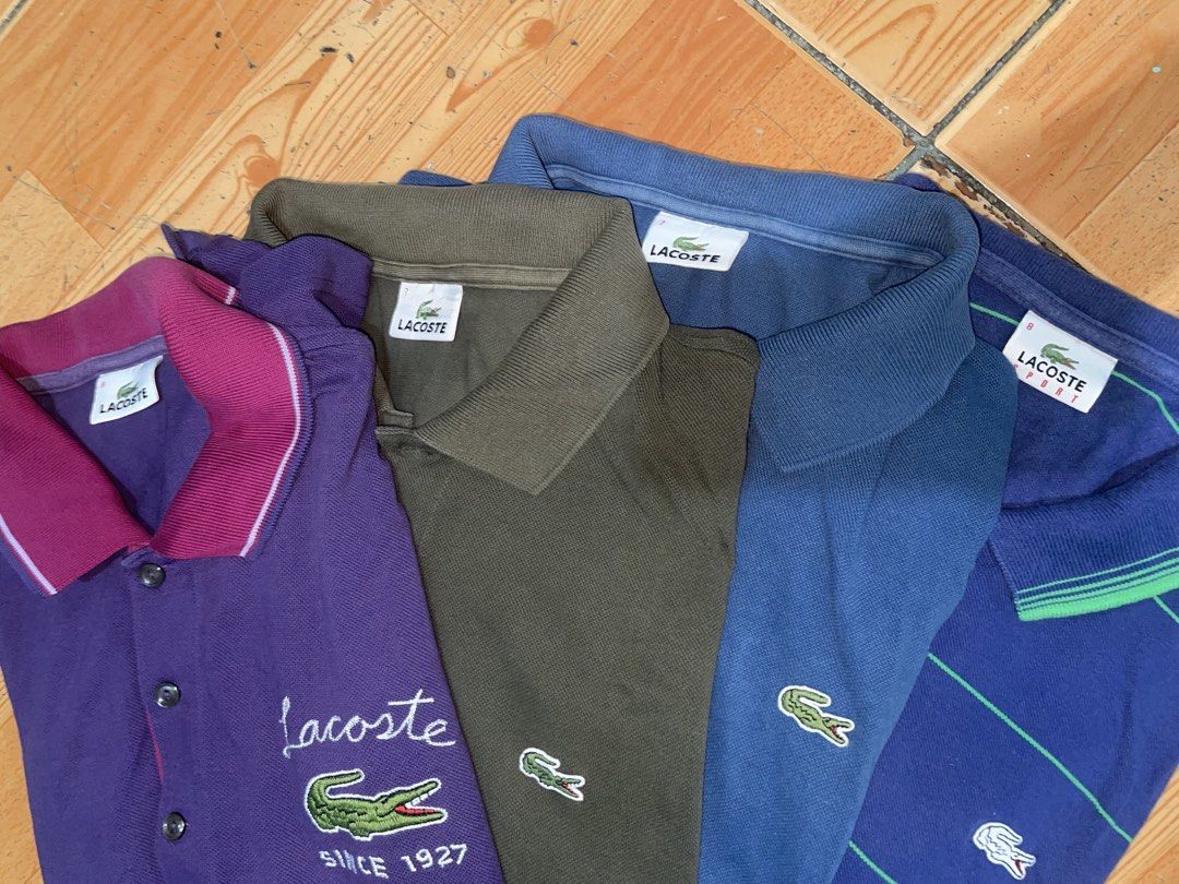 Lacoste Polo Shirts Bundle of 4 (Category: Tshirts & Polo Shirts ) located in Manila. Submitted by joshua_guimeroy. (Listing ID 1468530735, Image 2). Description: - Set of 4 authentic Lacoste polo shirts - Colors: Purple, olive green, solid blue, and striped blue - Tag sizes: 7 to 8 - Features iconic embroidered crocodile logo on the chest - Made with comfortable, standard cotton polo fabric - Designed with a classic buttoned collar - Ideal for c