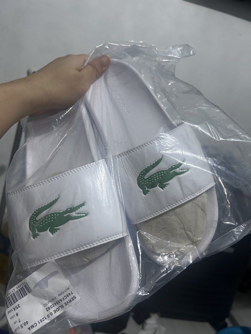 Lacoste Serve Slide Slides Sandals Black White (Category: Slippers & Slides) located in Manila. Submitted by jeremywayn81052 (Listing ID 1468530920, Image 3). Description: - 100% Brand new with tags and original plastic packaging - Available in Classic Black and White colorways - Bold, large embossed Lacoste crocodile logo on the strap - Textured footbed for slip-free grip and all-day comfort - Durable synthetic material construction - Buy single