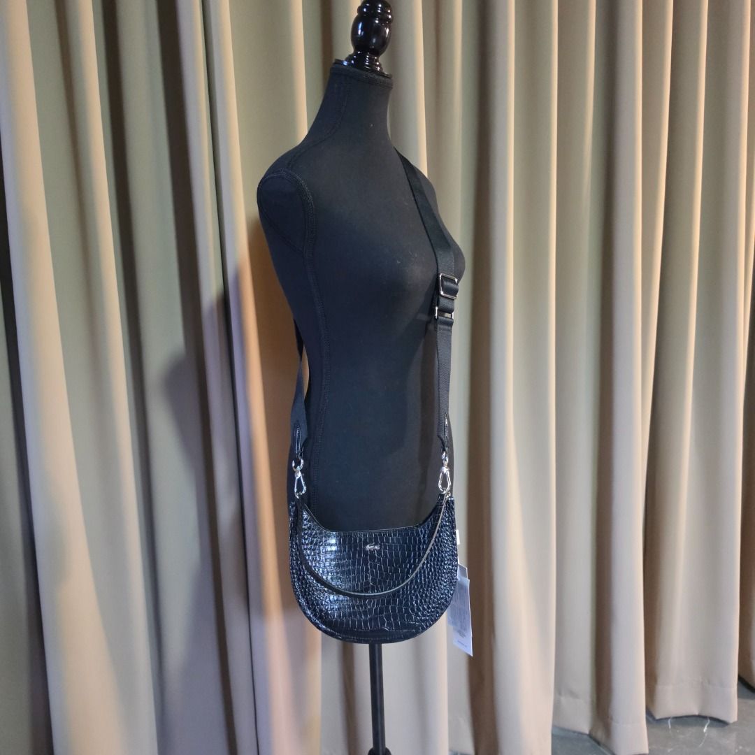 LACOSTE Small Chantaco Embossed Leather Half Moon Bag (Category: Cross-body Bags) located in Las Pinas. Submitted by my_opencloset (Listing ID 1468602175, Image 2). Description: - Brand new with store tag attached (P11,950) - 30% off from original price - With Lacoste Paperbag - With Lacoste Dustbag Size reference in pictures : Iphone 16 Promax.