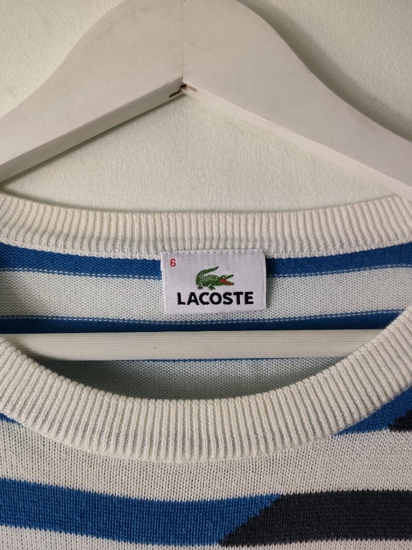 Lacoste Striped Knit Sweater Size 6 (Category: Longsleeves) located in Quezon City. Submitted by needforthrift (Listing ID 1468627155, Image 2). Description: - Brand: Lacoste - Style: Crewneck sweater with black and blue diagonal stripes - Size: Tagged Size 6 - dimension : 21 width 29 length - Features: Long sleeves, ribbed cuffs and hem, classic embroidered crocodile logo on the chest - Condition: Good overall, with some minor yellowing stains n