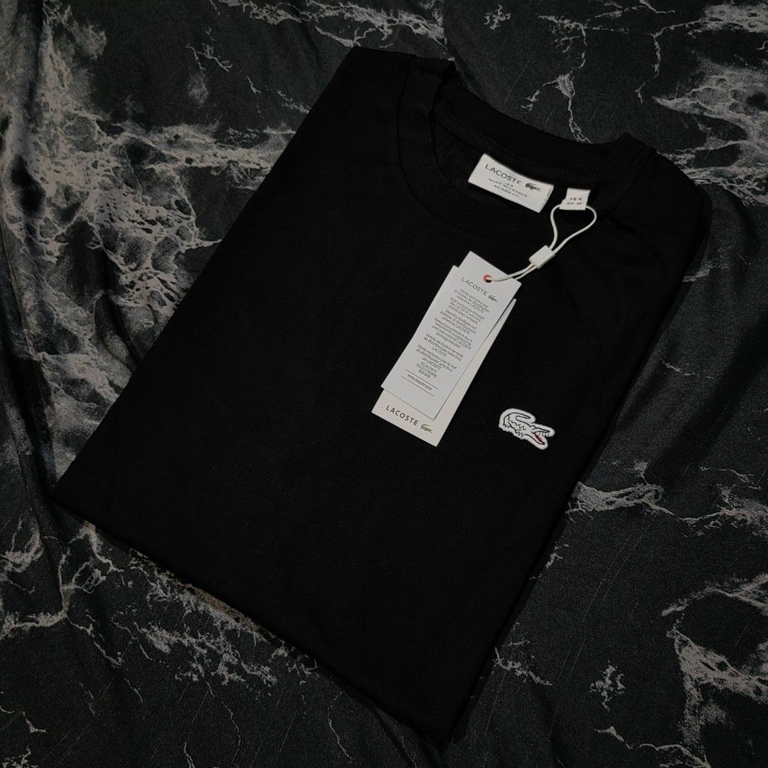 Lacoste Tshirt (Category: Activewear) located in Taguig. Submitted by mr.gbh (Listing ID 1468588375, Image 1). Description: Lacoste Basic Logo Tee Black Size: Medium To Large L-29/W-22 Excellent Condition Php, 699.