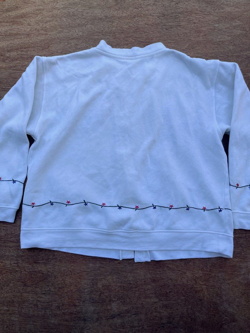 Lady Footlocker Cottage-core Cardigan (Category: Coats, Jackets and Outerwear) located in San Fernando. Submitted by p_thrifts (Listing ID 1468565907, Image 2). Description: - Brand: Lady Footlocker Casuals - Color: White with charming floral embroidery on chest, hem, and cuffs - Material: Soft and cozy cotton blend fleece - Style: Button-up front with a classic crew neck and long sleeves - Issue: Missing 2 buttons - Condition: Great pre-loved co