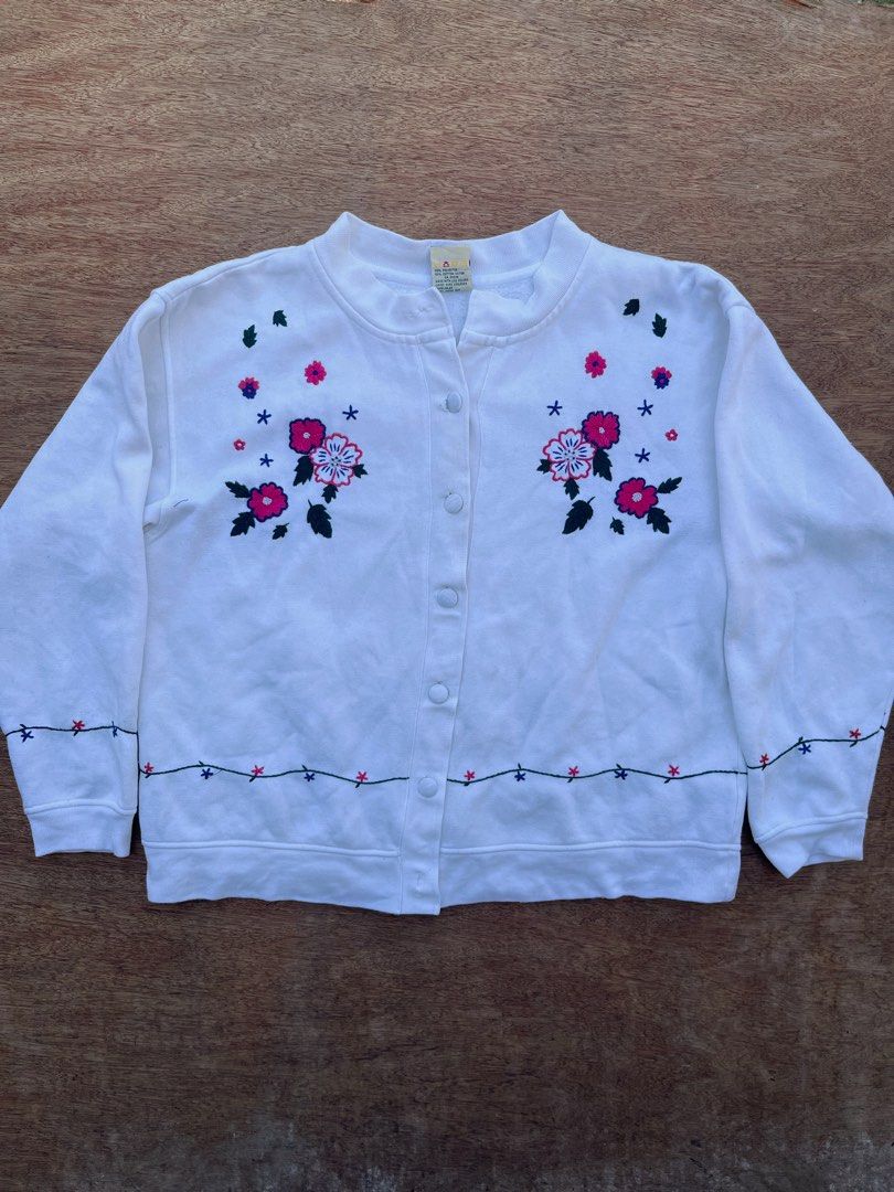 Lady Footlocker Cottage-core Cardigan (Category: Coats, Jackets and Outerwear) located in San Fernando. Submitted by p_thrifts (Listing ID 1468565907, Image 1). Description: - Brand: Lady Footlocker Casuals - Color: White with charming floral embroidery on chest, hem, and cuffs - Material: Soft and cozy cotton blend fleece - Style: Button-up front with a classic crew neck and long sleeves - Issue: Missing 2 buttons - Condition: Great pre-loved co