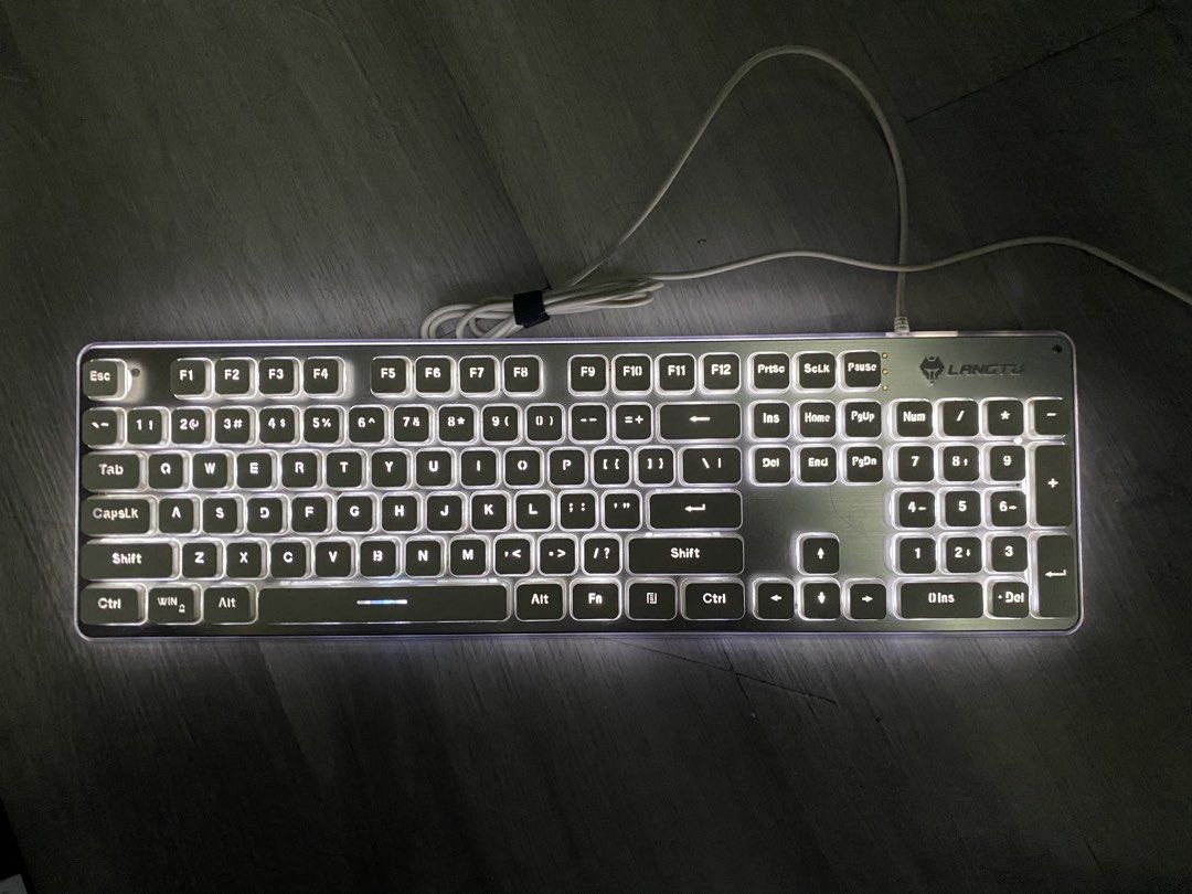 LANGTU L1 Wireless Silent Keyboard (Category: Computer Keyboard) located in Caloocan City. Submitted by anne_dcz (Listing ID 1468675719, Image 3). Description: Selling a LANGTU L1 wireless silent keyboard with white backlit keys, metallic silver panel, and full-sized layout. Perfect for both office and gaming setups. Plug-and-play ready!.