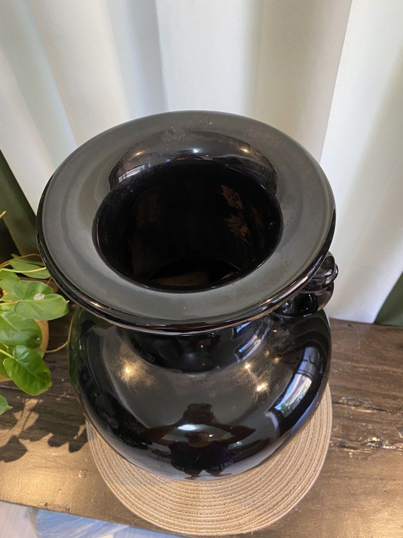Large Black Ceramic Vase with Animal Head Handles (Category: Vases & Decorative Bowls) located in San Pedro. Submitted by jingay81 (Listing ID 1468708555, Image 2). Description: - Large black ceramic vase with a sleek high-gloss finish - Features detailed animal head handles on both sides - Elegant flared rim and wide bulbous body - Note: Has a noticeable repair patch near the base, as shown in the last photo - Makes a bold statement piece for an