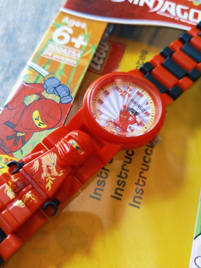 LEGO Ninjago Watch 9004254 (Category: Babies & Kids Fashion) located in Pasig City. Submitted by babylove2003 (Listing ID 1468624919, Image 2). Description: LEGO Ninjago kids watch, model 9004254. Red and black interchangeable link strap. Includes a buildable Kai minifigure integrated right into the band. Analog face with character graphic. Original box and inserts included. Fun accessory for young fans of the series. Perfectly working..