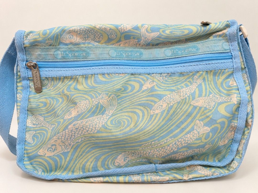 LeSportsac Crossbody Bag (Category: Cross-body Bags) located in Manila. Submitted by littleclosetfindsmnl (Listing ID 1468554821, Image 1). Description: LeSportsac Fish Print Messenger Bag 🩵 Vintage-style LeSportsac crossbody bag in a unique blue and yellow fish print. Lightweight and practical with zippered pockets. Pre-loved condition with signs of use. .