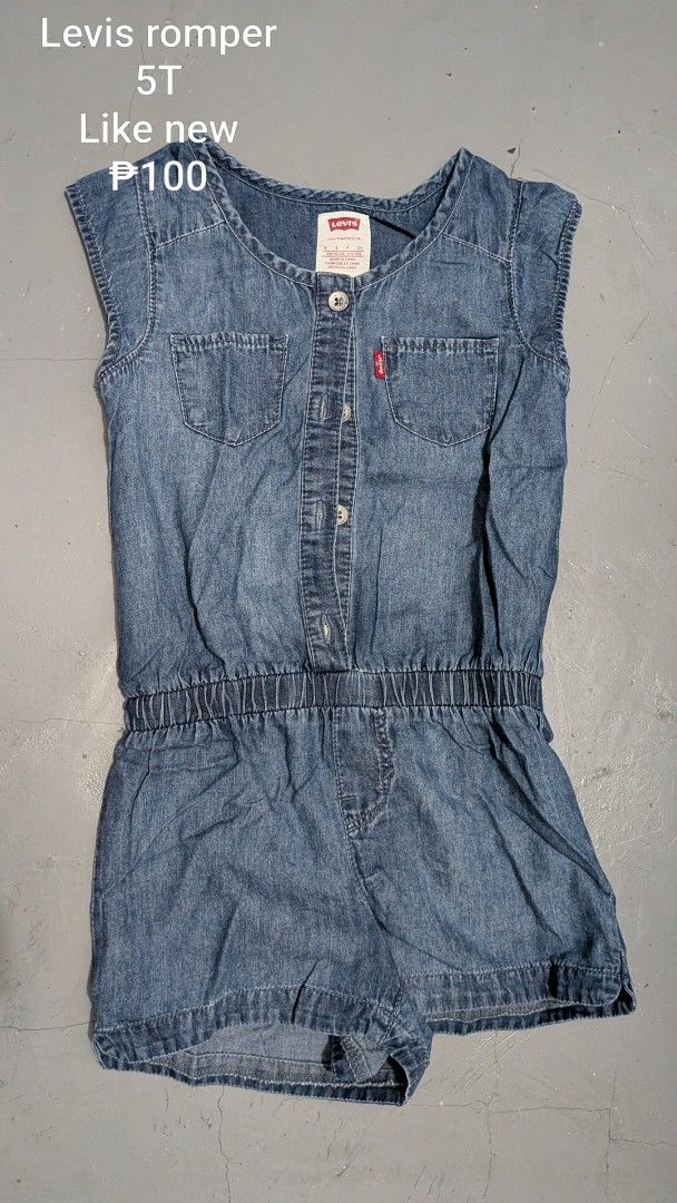 Levis denim romper 5T (Category: Babies & Kids Fashion) located in Tanay. Submitted by misyelleysim (Listing ID 1468614861, Image 1). Description: - Brand: Levi's - Size: 5T (Toddler) - Wash: Light wash denim - Closure: Convenient button-front - Details: Two chest pockets with iconic red Levi's tab - Comfort: Elastic waistband for easy fit and movement - Style: Short sleeves and shorts, ideal for warm weather.