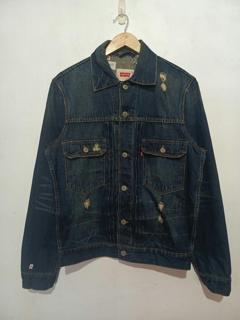 Levi's Distressed Denim Jacket Size M Slim Fit (Category: Coats, Jackets and Outerwear) located in Baguio. Submitted by miisthyshop.ph (Listing ID 1468528405, Image 1). Description: - Brand: Levi's - Style: Slim fit denim jacket with distressed details and front rips - Color: Dark wash blue - Size: Men's Medium (Tag: 170/88A) - Material: 100% Cotton - Details: Metallic button-up closure, standard collar, button cuffs, and classic red tab - Origin