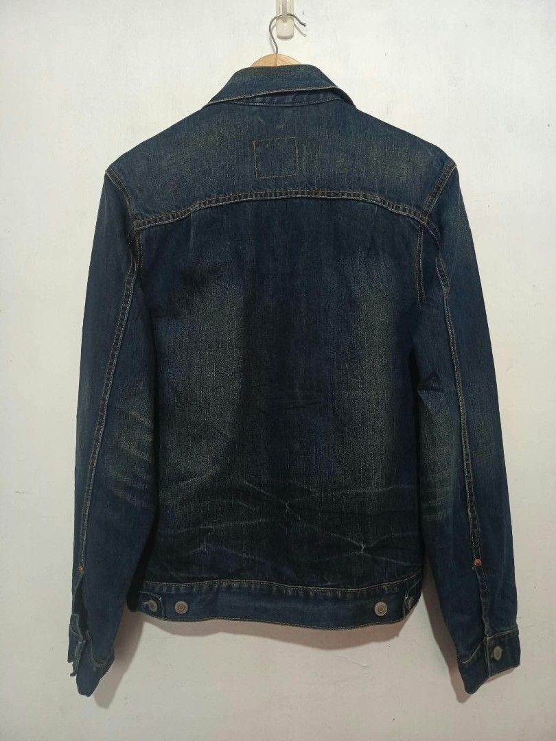 Levi's Distressed Denim Jacket Size M Slim Fit (Category: Coats, Jackets and Outerwear) located in Baguio. Submitted by miisthyshop.ph (Listing ID 1468528405, Image 2). Description: - Brand: Levi's - Style: Slim fit denim jacket with distressed details and front rips - Color: Dark wash blue - Size: Men's Medium (Tag: 170/88A) - Material: 100% Cotton - Details: Metallic button-up closure, standard collar, button cuffs, and classic red tab - Origin