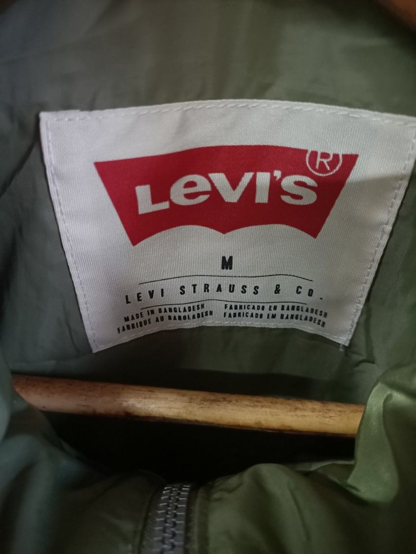 Levi's Green Bomber Jacket Size M (Category: Coats, Jackets and Outerwear) located in Bayombong. Submitted by rheaaa00530 (Listing ID 1468625177, Image 3). Description: - Brand: Levi's - Style: Bomber jacket - Color: Olive green - Size: Medium - Condition: Brand new with original store tag attached - Details: Zip-up front with snap buttons, two front cargo pockets with button closures, high collar, ribbed cuffs and hem.