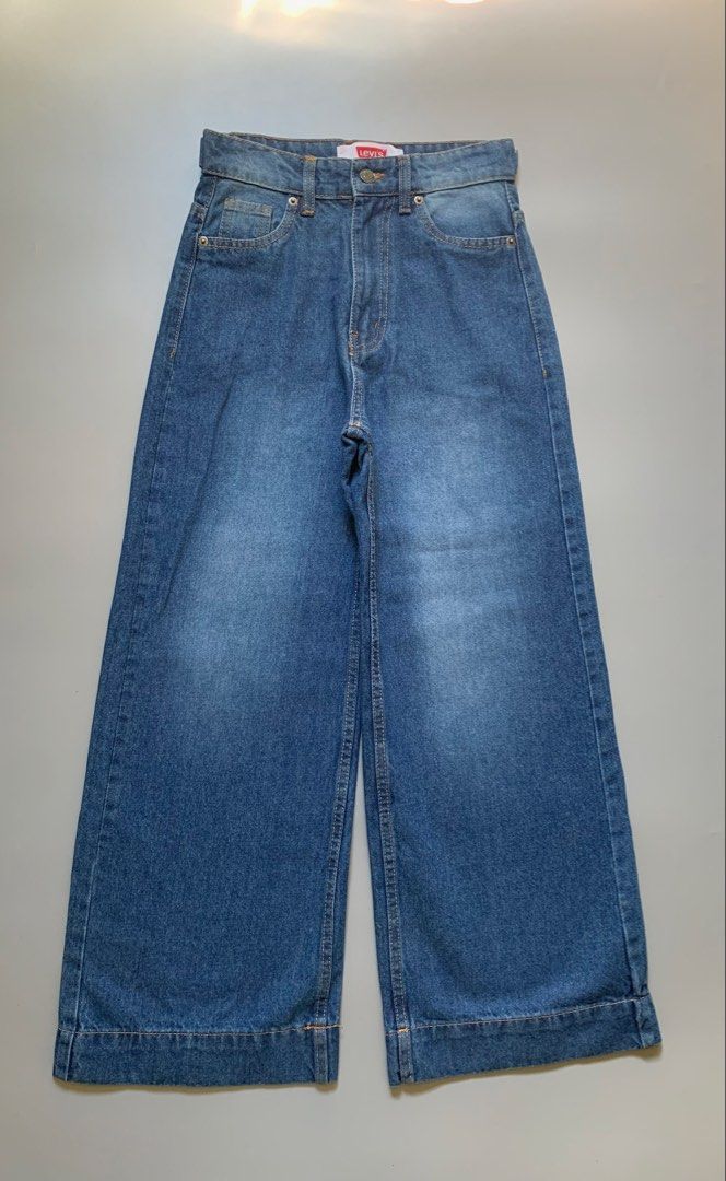 Levi's Wide Leg Denim Jeans (Category: Jeans) located in Manila. Submitted by swift_royalfox.18 (Listing ID 1468659623, Image 2). Description: - Brand: Levi's - Style: Wide leg jeans with flat hem detail - Wash: Classic medium wash denim - Fit: High-waisted with front button closure - Details: Standard five-pocket layout and iconic red label on waistband.