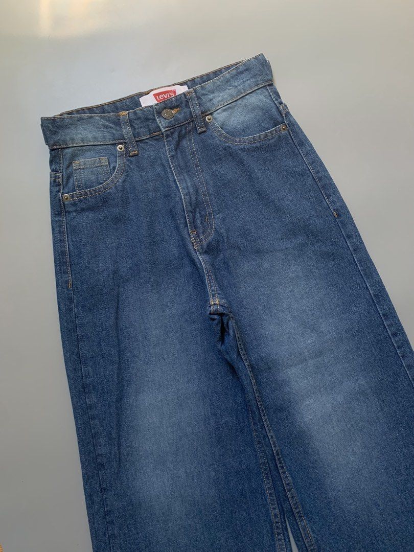 Levi's Wide Leg Denim Jeans (Category: Jeans) located in Manila. Submitted by swift_royalfox.18 (Listing ID 1468659623, Image 3). Description: - Brand: Levi's - Style: Wide leg jeans with flat hem detail - Wash: Classic medium wash denim - Fit: High-waisted with front button closure - Details: Standard five-pocket layout and iconic red label on waistband.