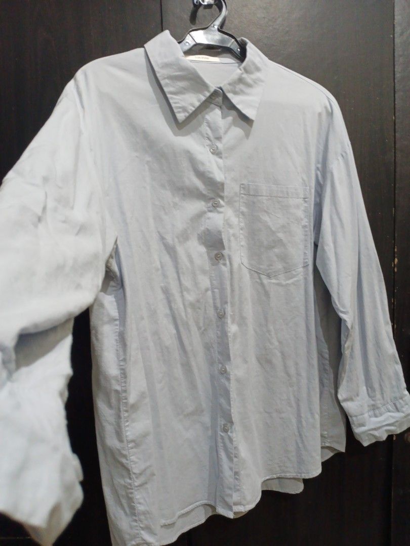 Light blue long-sleeve button-up shirt (Category: Longsleeves) located in Manila. Submitted by ggarage.sale (Listing ID 1468688799, Image 1). Description: - Color: Light blue - Style: Button-up with classic collar and standard button cuffs - Fit: Relaxed fit, long sleeves - Condition: Good, just needs a quick iron due to storage - Versatile piece for work or weekend wear.