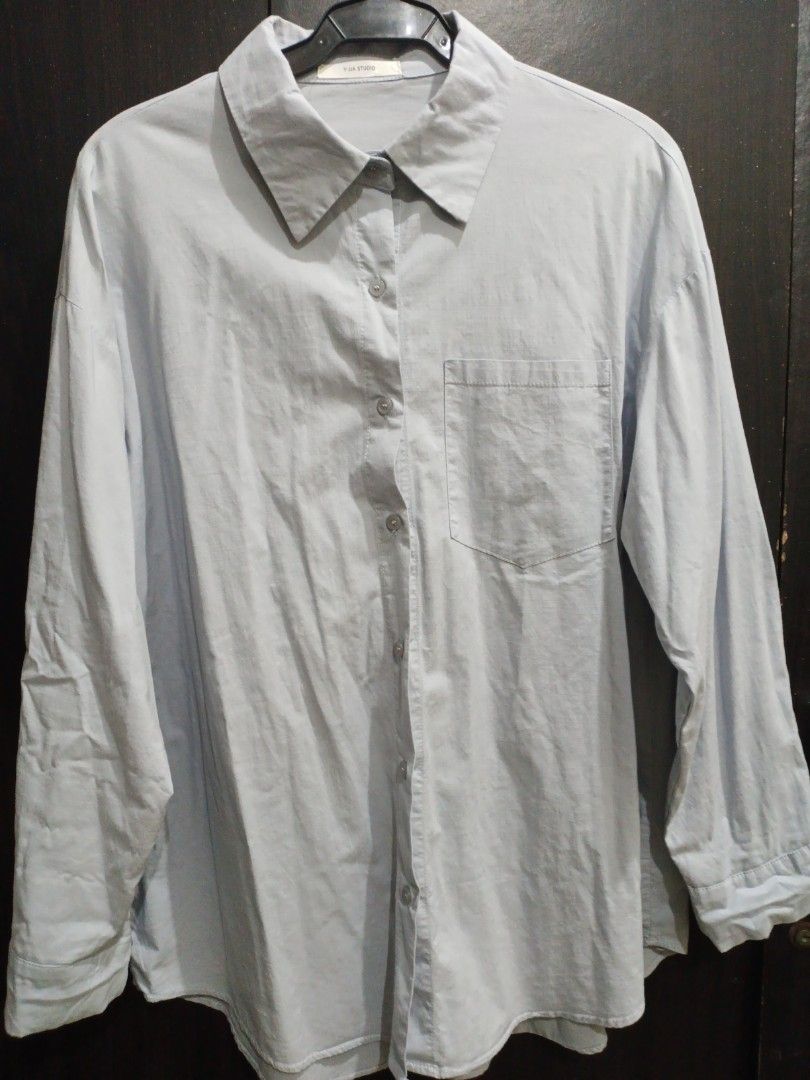 Light blue long-sleeve button-up shirt (Category: Longsleeves) located in Manila. Submitted by ggarage.sale (Listing ID 1468688799, Image 2). Description: - Color: Light blue - Style: Button-up with classic collar and standard button cuffs - Fit: Relaxed fit, long sleeves - Condition: Good, just needs a quick iron due to storage - Versatile piece for work or weekend wear.