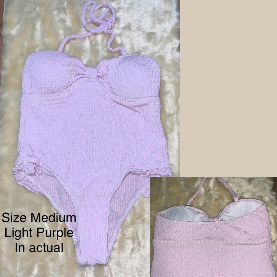 Light Purple Halter One-Piece Swimsuit Size Medium (Category: Bikinis & Swimsuits) located in Pasay City. Submitted by zaceeee (Listing ID 1468711809, Image 1). Description: - Size: Medium - Color/Fabric: Light purple textured crinkle fabric - Support: Halter neck tie with molded cups and underwire - Design: Ruffle trim along high-cut leg openings - Coverage: Full coverage back with white inner lining - Condition: Fresh, clean, and ready for the 