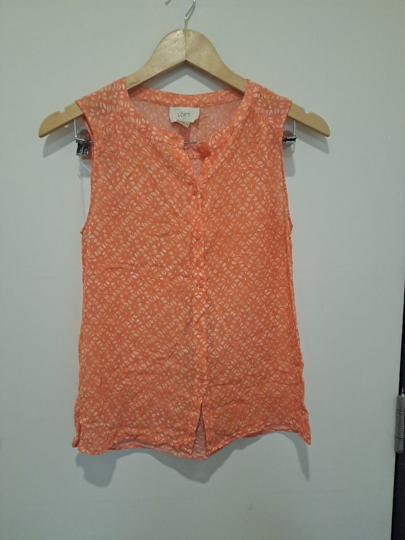 Loft by Ann Taylor (Category: Sleeveless) located in Manila. Submitted by joanbalde39643 (Listing ID 1468612282, Image 1). Description: This is a sleeveless, button-down blouse from the brand LOFT. It features a vibrant peach or coral orange color patterned with all-over white micro-prints.