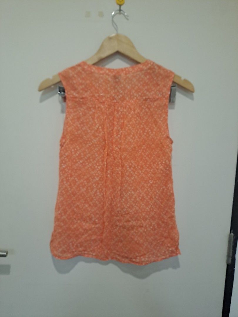 Loft by Ann Taylor (Category: Sleeveless) located in Manila. Submitted by joanbalde39643 (Listing ID 1468612282, Image 3). Description: This is a sleeveless, button-down blouse from the brand LOFT. It features a vibrant peach or coral orange color patterned with all-over white micro-prints.