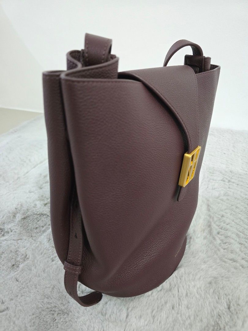 LOMAFE Velisse in Cabernet (Category: Cross-body Bags) located in San Fernando. Submitted by icasarmiepal.declutter (Listing ID 1468682353, Image 3). Description: - Color: Deep burgundy - Material: Textured pebbled leather - Design: Structured round circular base with clean edge stitching - Versatility: Includes an adjustable crossbody strap and a top handle loop - Usage: Compact everyday bag - Bought at SRP 13,800. Selling for 12,500 (slightly n