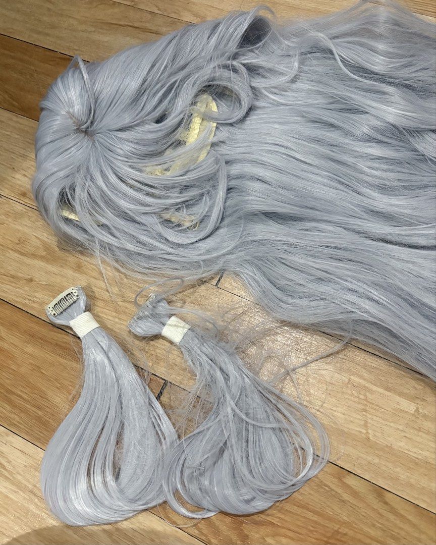 Long grey cosplay wig with clip-on extensions (Category: Hair Accessories) located in Rizal. Submitted by stylishfitz (Listing ID 1468611459, Image 2). Description: Just need to brush - Color: Light grey - Material: Soft, thick synthetic hair - Features: Net lining with built-in combs for a secure fit - Includes: Two extra clip-in weft pieces - Ideal for: Everyday styling or anime cosplay - Condition: Kept in storage.