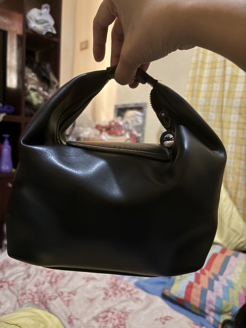 Longchamp Black Leather Handbag (Category: Luxury Bags & Wallets) located in Manila. Submitted by bellepatal57826 (Listing ID 1468533199, Image 2). Description: - Brand: Longchamp - Color: Classic Black - Material: Smooth genuine leather with silver-tone hardware - Closure: Front flap with snap button and secure top zip - Design: Double handle, compact size for daily essentials - Condition: Clean interior and sturdy stitching throughout.