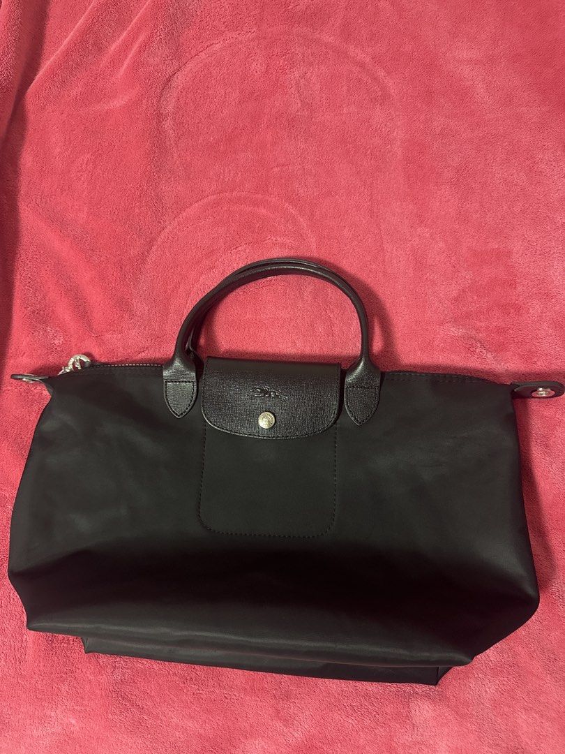 Longchamp black nylon tote handbag (Category: Luxury Bags & Wallets) located in Manila. Submitted by baristadrinkluvr (Listing ID 1468687134, Image 1). Description: - Longchamp classic tote bag in timeless black nylon - Black leather handles and flap top with secure snap closure - Top zipper keeps your daily essentials safe - Stylish silver-tone hardware accents - Lightweight, foldable design perfect for daily commute or travel - Versatile minima