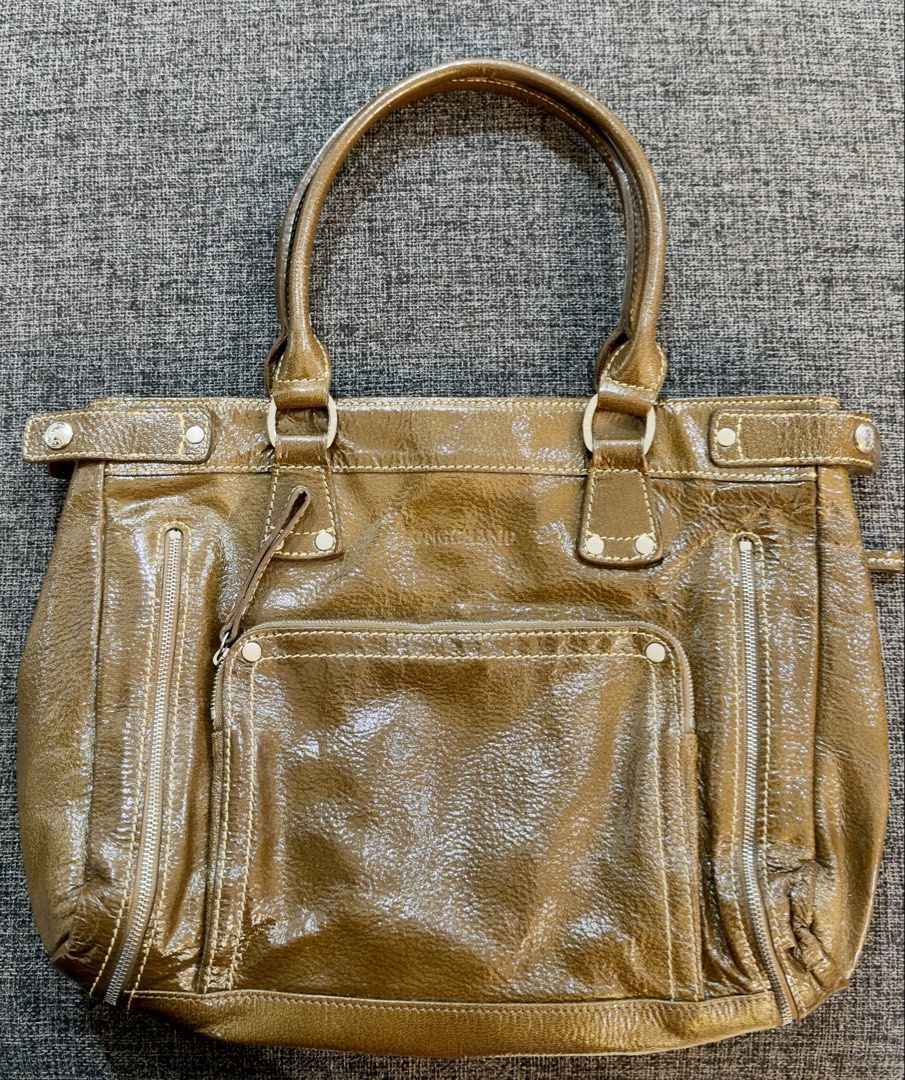 Longchamp Bronze Patent Tote / Shoulder Bag (Category: Luxury Bags & Wallets) located in Calamba. Submitted by doublegm (Listing ID 1468525427, Image 1). Description: - Brand: Longchamp - Material: Bronze patent leather with silver-tone hardware - Straps: Double shoulder straps - Exterior Storage: Two vertical side zipper pockets and one front snap-flap pocket - Closure: Top magnetic closure - Interior: Light blue signature fabric lining with sli