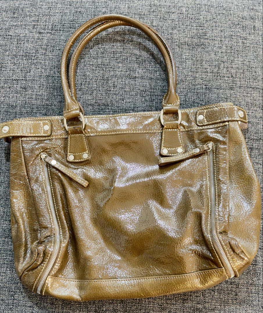 Longchamp Bronze Patent Tote / Shoulder Bag (Category: Luxury Bags & Wallets) located in Calamba. Submitted by doublegm (Listing ID 1468525427, Image 2). Description: - Brand: Longchamp - Material: Bronze patent leather with silver-tone hardware - Straps: Double shoulder straps - Exterior Storage: Two vertical side zipper pockets and one front snap-flap pocket - Closure: Top magnetic closure - Interior: Light blue signature fabric lining with sli