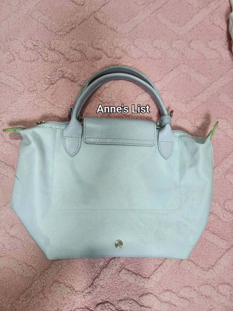 Longchamp (Inspo) Light Gray Le Pliage Bag (Category: Luxury Bags & Wallets) located in Santa Maria. Submitted by anne_s.list (Listing ID 1468684787, Image 3). Description: - Inspo Longchamp bag in a lovely light gray shade - Made in Tunisia - Secure zipper closure with branded silver pull tab - Comes with a detachable shoulder strap (stored inside) - Visible Dirt on the fabric exterior and corners (need wash) - Smooth-gliding zipper - Premium Qu