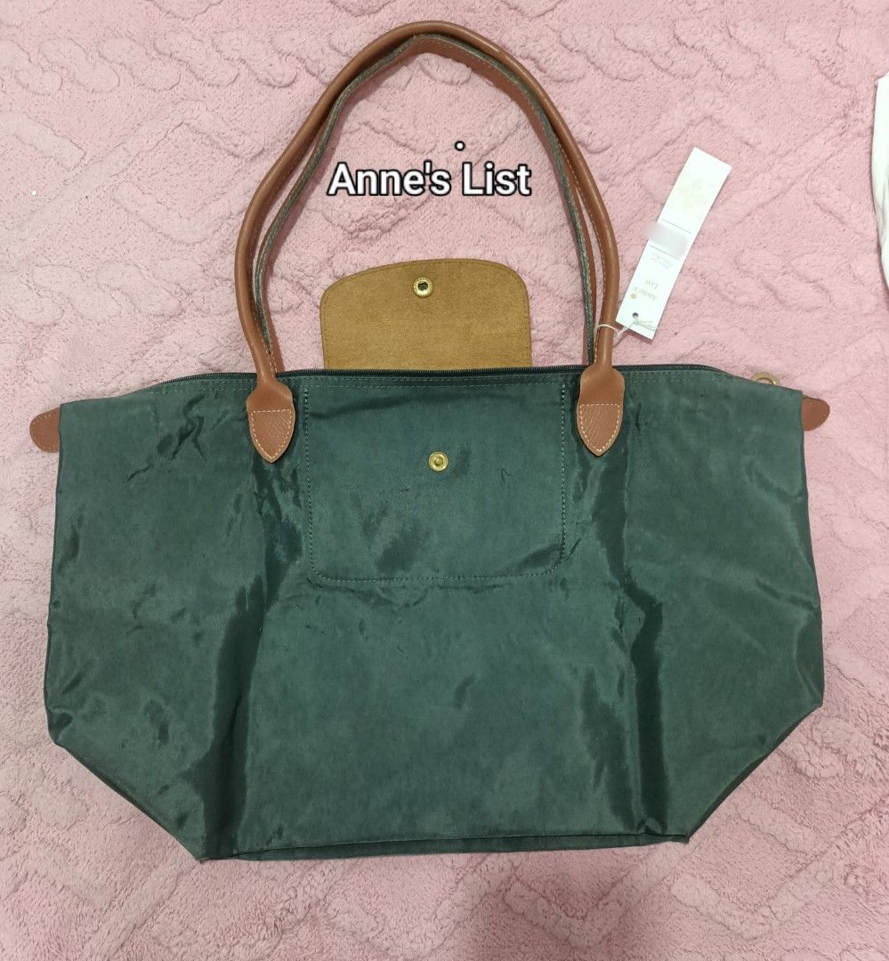Longchamp Le Pliage Graphite Nylon Tote Bag Long Handle (Category: Luxury Bags & Wallets) located in Santa Maria. Submitted by anne_s.list (Listing ID 1468684247, Image 3). Description: - Authentic Longchamp Graphite Nylon tote bag (Vintage) - Brown leather handles and top flap with gold-tone snap closure - Secure zipper top opening - Spacious interior with sturdy bottom corners - Size Large , Long Handle - Perfect, stylish everyday shoulder bag.