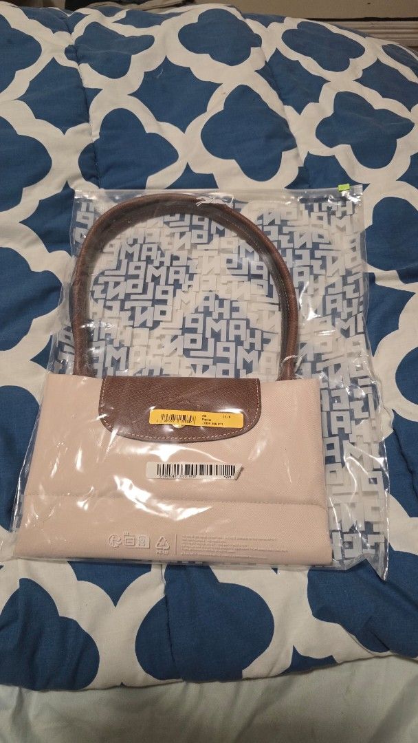 Longchamp Le Pliage Paper Tote Bag (Category: Luxury Bags & Wallets) located in Las Pinas. Submitted by insouciant_worrier (Listing ID 1468623522, Image 1). Description: Slightly negotiable - Authentic Longchamp Le Pliage Tote Bag in Papier (Style Code: L1899089P71) - Brand new, unopened in original packaging - Includes original store tags from Rustan's and branded dust bag - Signature brown leather handles and flap with snap button closure - Spa