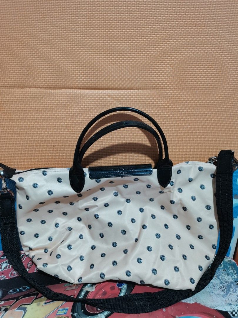 Longchamp Polka Dot Handbag with Shoulder Strap (Category: Luxury Bags & Wallets) located in Lucena. Submitted by jjbrandedcloset (Listing ID 1468576094, Image 2). Description: Cream and black polka dot Longchamp bag with dual top handles and detachable shoulder strap. Dark flap closure with snap button and zipped main compartment. Interior lining shows some stains and marks from previous use. Exterior fabric clean overall with minor wear..