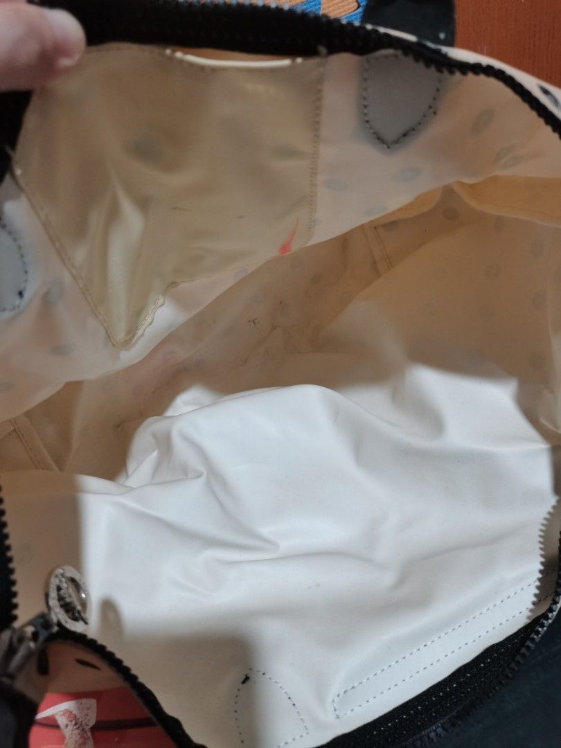 Longchamp Polka Dot Handbag with Shoulder Strap (Category: Luxury Bags & Wallets) located in Lucena. Submitted by jjbrandedcloset (Listing ID 1468576094, Image 3). Description: Cream and black polka dot Longchamp bag with dual top handles and detachable shoulder strap. Dark flap closure with snap button and zipped main compartment. Interior lining shows some stains and marks from previous use. Exterior fabric clean overall with minor wear..