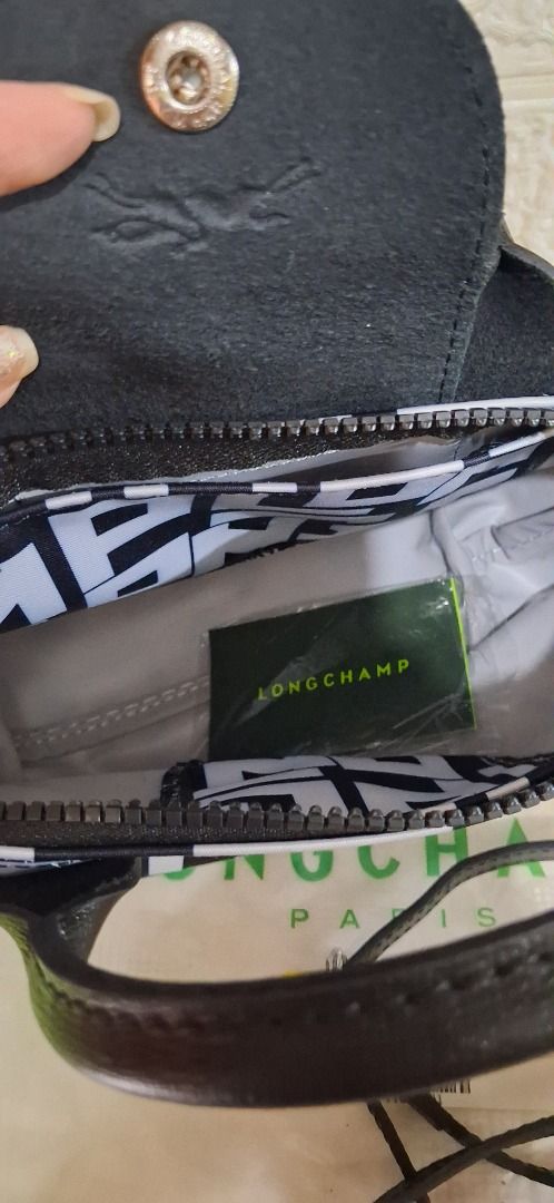 Longchamp Top Handle Bag Black White Letter Print (Category: Luxury Bags & Wallets) located in Manila. Submitted by katkween23 (Listing ID 1468513589, Image 3). Description: - Authentic Longchamp top handle bag - Trendy black and white letter print pattern - Includes a detachable black leather strap and lime green accent tag - Secure top flap with snap closure and zip entry - Interior features a slip pocket and Longchamp branding - Complete with 