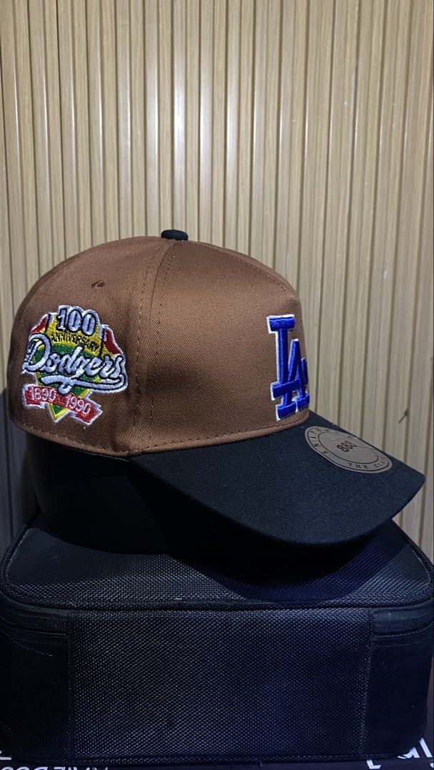 Los Angeles Dodgers Snapback Cap Brown Black (Category: Caps & Hats) located in Manila. Submitted by _kyndzgrt (Listing ID 1468682688, Image 2). Description: - Authentic LA Dodgers snapback cap in stylish brown and black - Eye-catching blue embroidered LA logo on the front - Special side patch commemorating the team's 100th anniversary (1890-1990) - Flat brim complete with the original round metallic sticker - Adjustable snap closure at the back 