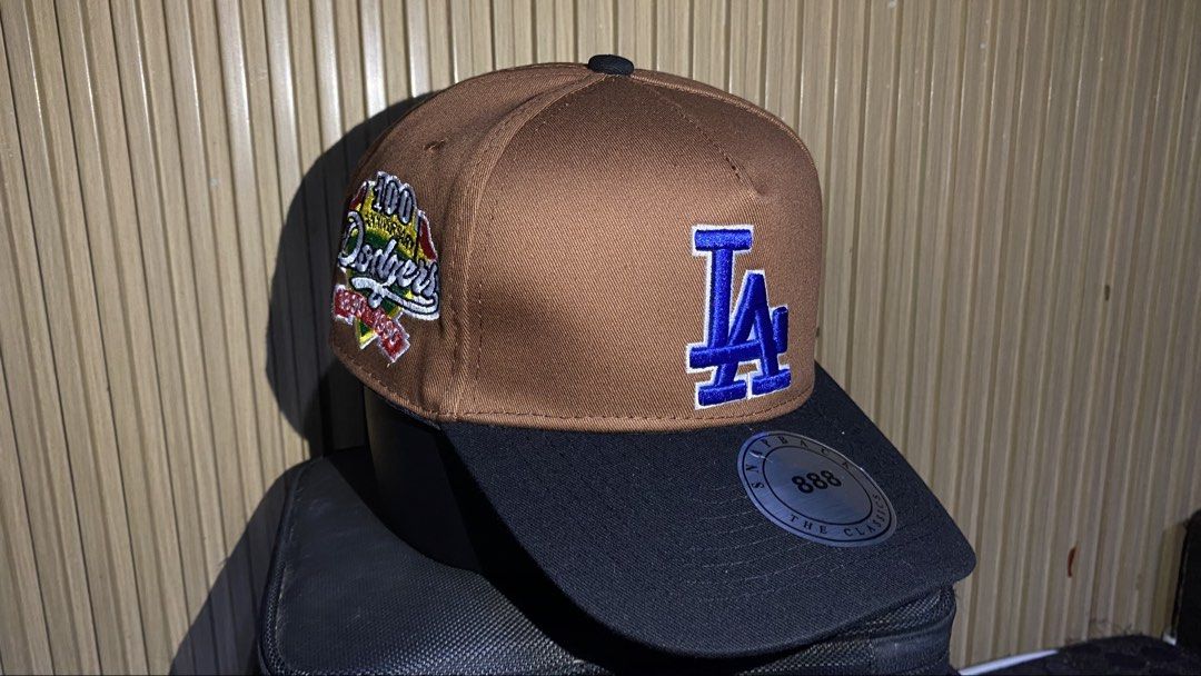Los Angeles Dodgers Snapback Cap Brown Black (Category: Caps & Hats) located in Manila. Submitted by _kyndzgrt (Listing ID 1468682688, Image 1). Description: - Authentic LA Dodgers snapback cap in stylish brown and black - Eye-catching blue embroidered LA logo on the front - Special side patch commemorating the team's 100th anniversary (1890-1990) - Flat brim complete with the original round metallic sticker - Adjustable snap closure at the back 