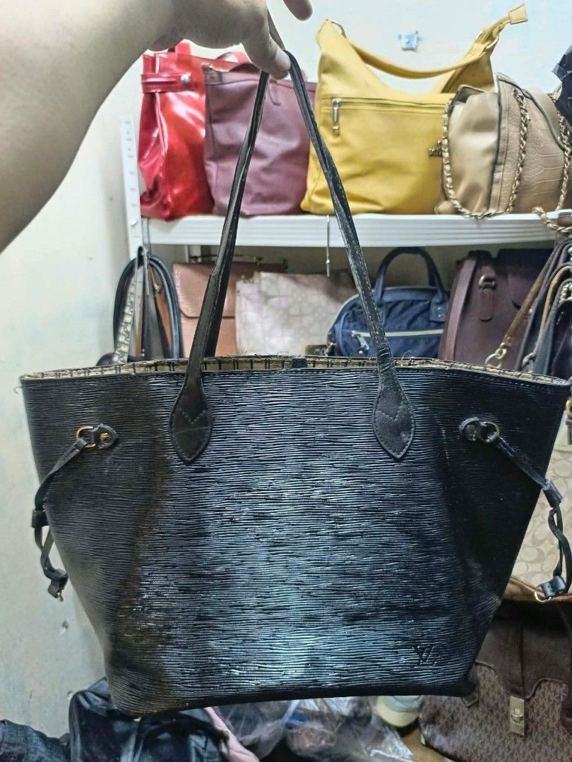 Louis Vuitton Black Epi Leather Tote Bag (Category: Luxury Bags & Wallets) located in Manila. Submitted by dei03_diz (Listing ID 1468544700, Image 1). Description: - Brand: Louis Vuitton - Material: Durable Black Epi leather - Hardware: Gold-tone accents with side drawstrings - Straps: Dual comfortable shoulder straps - Interior: Striped fabric lining with a convenient zipper pocket and cloth tags - Origin: Made in France stamp on interior leathe