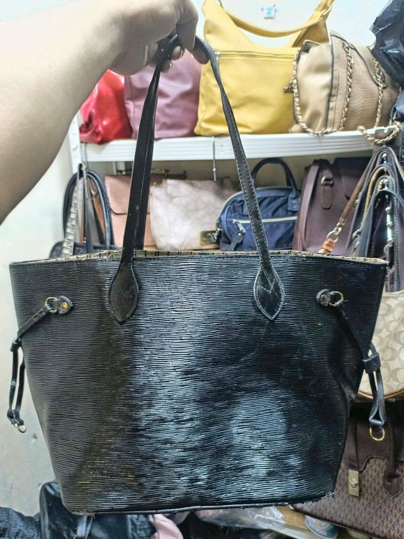 Louis Vuitton Black Epi Leather Tote Bag (Category: Luxury Bags & Wallets) located in Manila. Submitted by dei03_diz (Listing ID 1468544700, Image 2). Description: - Brand: Louis Vuitton - Material: Durable Black Epi leather - Hardware: Gold-tone accents with side drawstrings - Straps: Dual comfortable shoulder straps - Interior: Striped fabric lining with a convenient zipper pocket and cloth tags - Origin: Made in France stamp on interior leathe