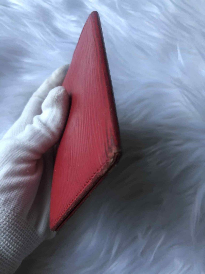 Louis Vuitton Epi Red Card Holder (Category: Luxury Bags & Wallets) located in Tarlac. Submitted by tokaidostoreexpress2 (Listing ID 1468644415, Image 2). Description: - Authentic Louis Vuitton card holder in vibrant red Epi leather - Distinct textured grain all over with subtle monogram initials stamped on the front corner - Slim profile designed to easily fit in pockets or small bags - Condition: Noticeable wear and rubbing on edges and corners